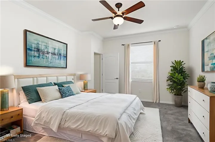 Bedroom featuring carpet, crown molding, and ceiling fan