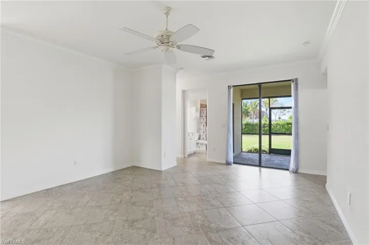 Empty room with ornamental molding and ceiling fan