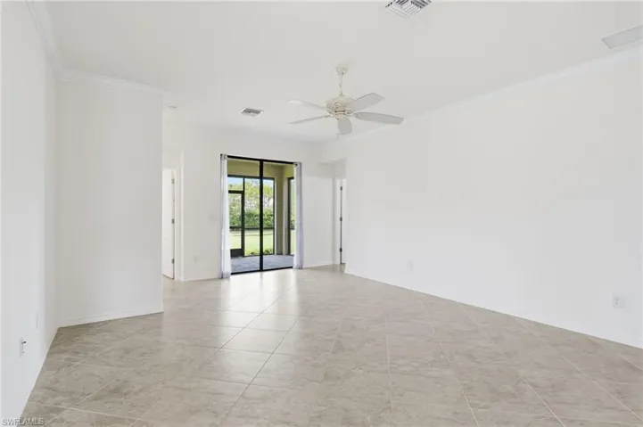 Unfurnished room featuring crown molding and ceiling fan