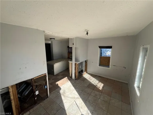 Unfurnished living room featuring a textured ceiling