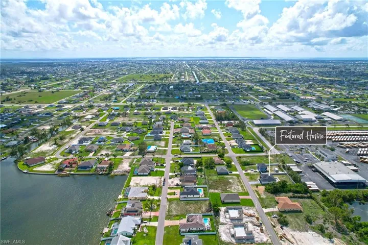 Aerial perspective of suburban area with a nearby body of water