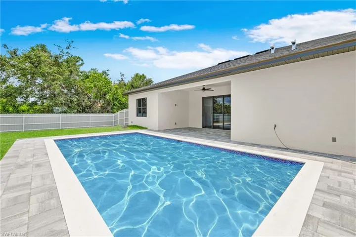 View of swimming pool with a ceiling fan, a patio area, and a fenced backyard