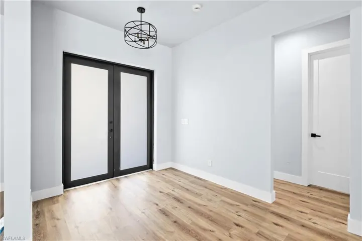 Entrance foyer with light wood finished floors and french doors