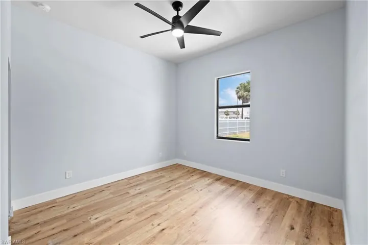 Empty room featuring light wood-style flooring and a ceiling fan