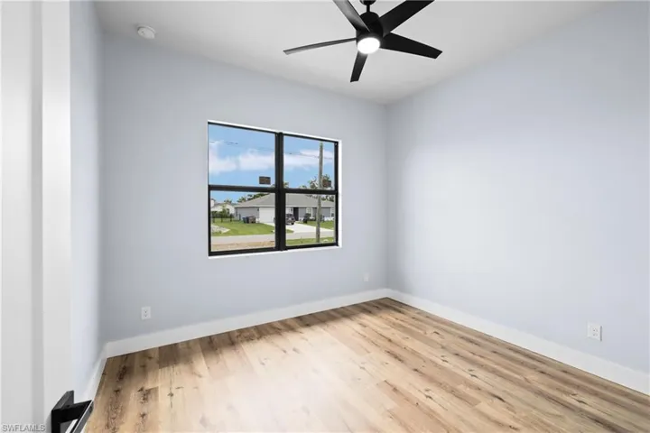 Unfurnished room with light wood finished floors and ceiling fan
