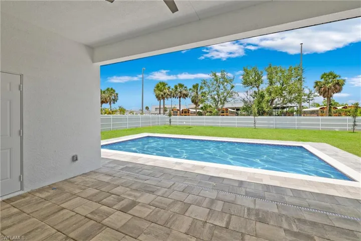 View of swimming pool with a patio and a fenced backyard
