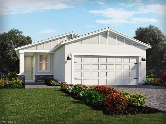 View of front of property featuring a front lawn and a garage
