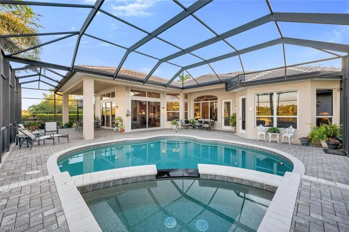 View of pool with ceiling fan, a lanai, an outdoor hangout area, an in ground hot tub, and a patio