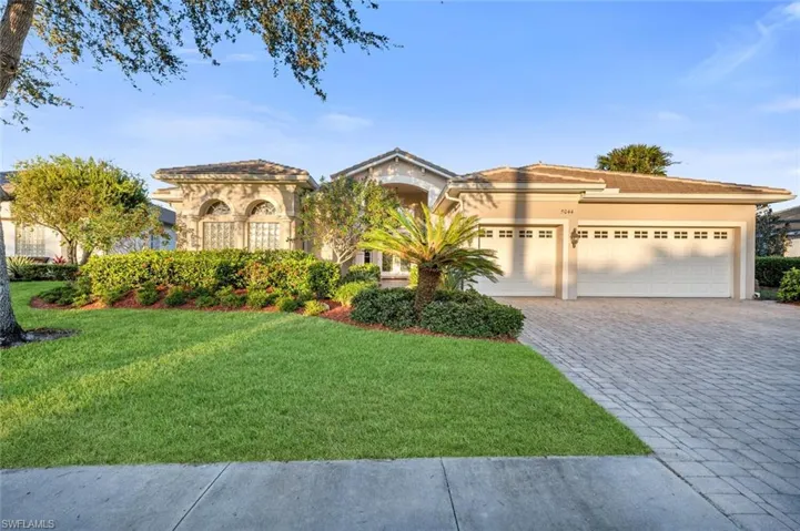 Mediterranean / spanish home with a front lawn and a garage