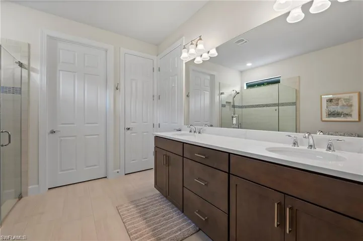 Bathroom with vanity and a shower with door