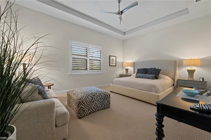 Bedroom featuring ceiling fan and a raised ceiling