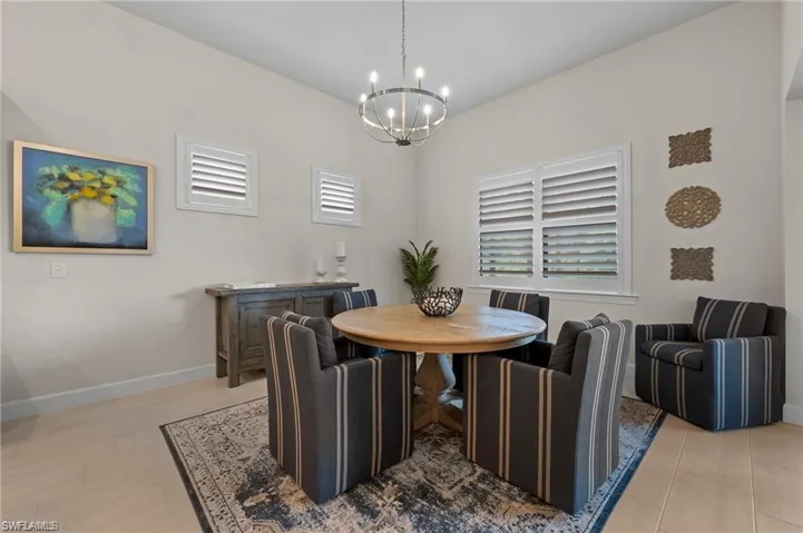 Dining area featuring plenty of natural light and a notable chandelier