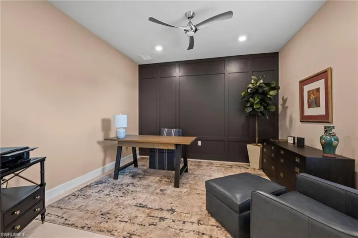 Office featuring accent wall and ceiling fan