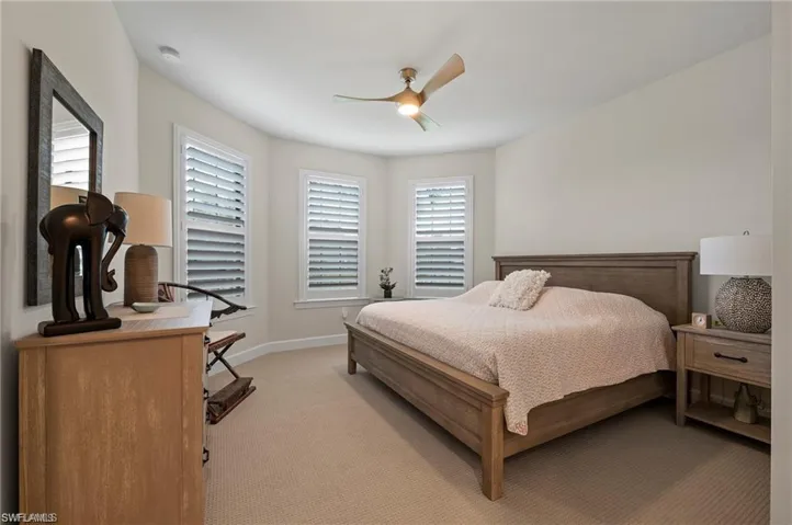 Carpeted bedroom with ceiling fan