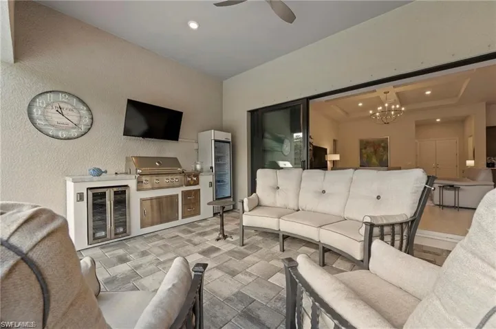 View of patio / terrace featuring wine cooler, outdoor lounge area, and a grill