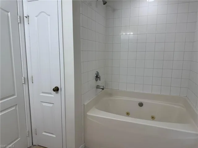 Full bath with a combined bath / shower with jetted tub