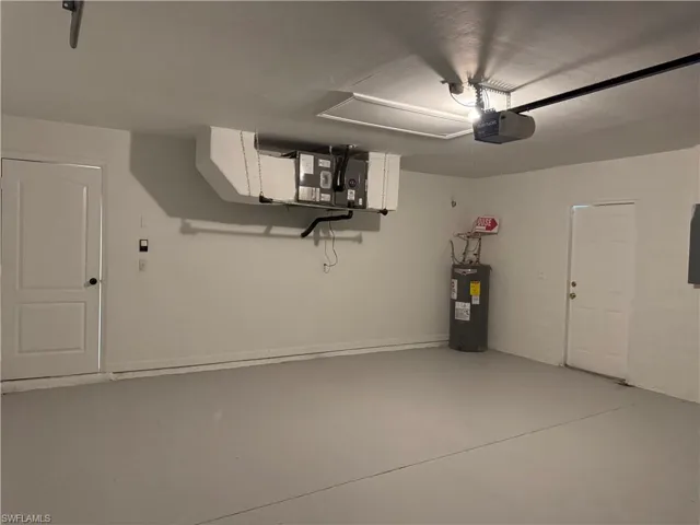 Garage with water heater and a garage door opener