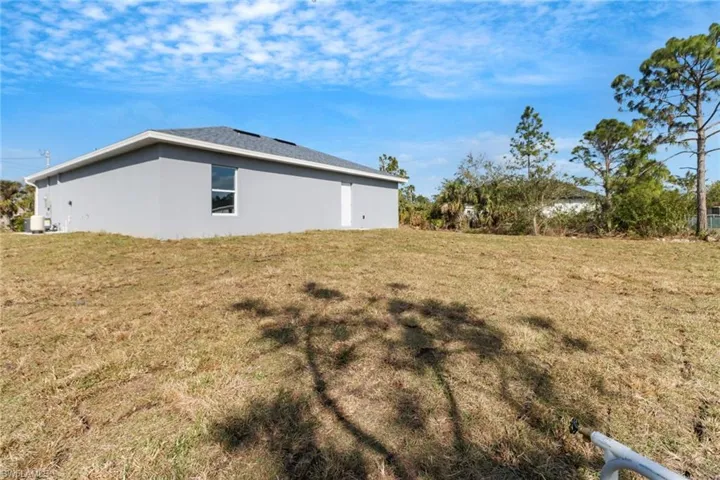 View of side of home with a lawn