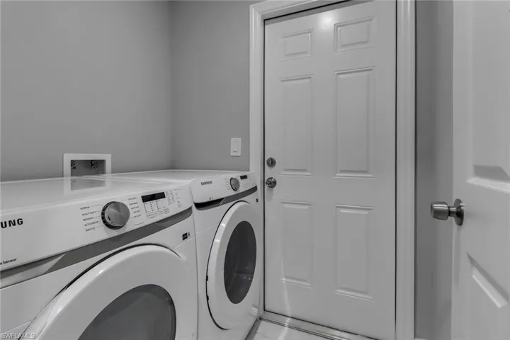 Laundry area with washing machine and clothes dryer