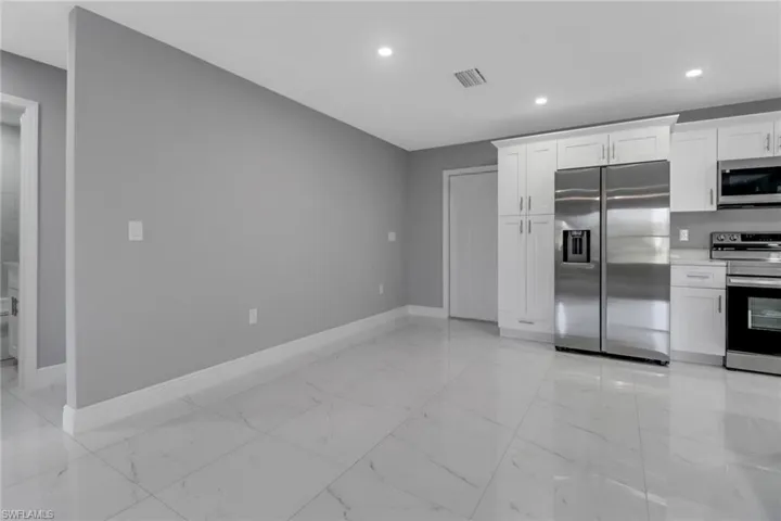 Kitchen with white cabinets and appliances with stainless steel finishes