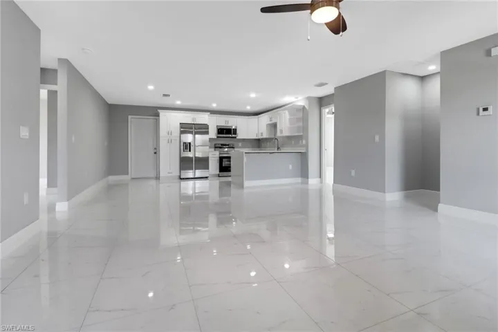 Unfurnished living room with ceiling fan
