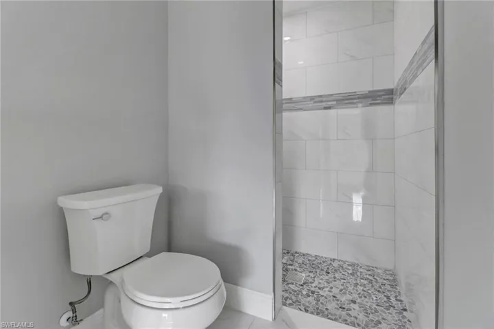 Bathroom with a tile shower and toilet