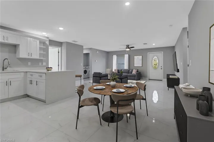 Dining room featuring washer / clothes dryer, sink, and ceiling fan
