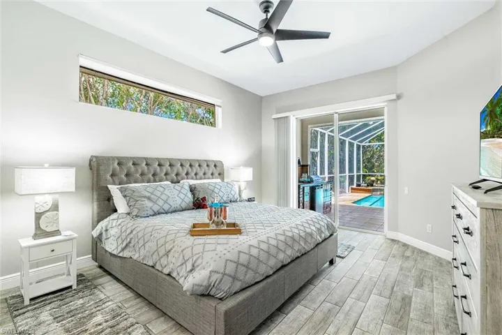 The primary bedroom has a king-size bed & sliders to the pool