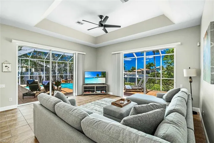 The living room has ample seating & a flat-screen TV