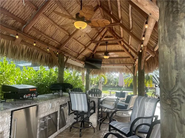 View of patio with a gazebo, a grill, ceiling fan, and exterior kitchen
