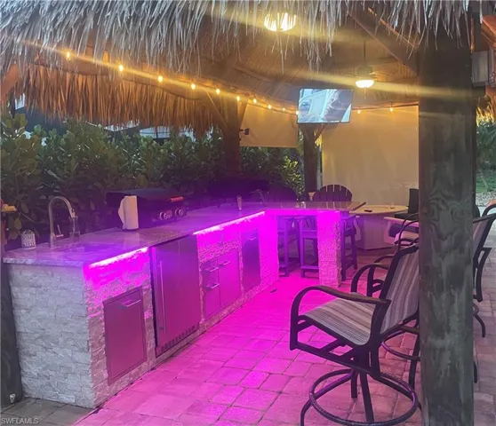 View of patio featuring exterior bar