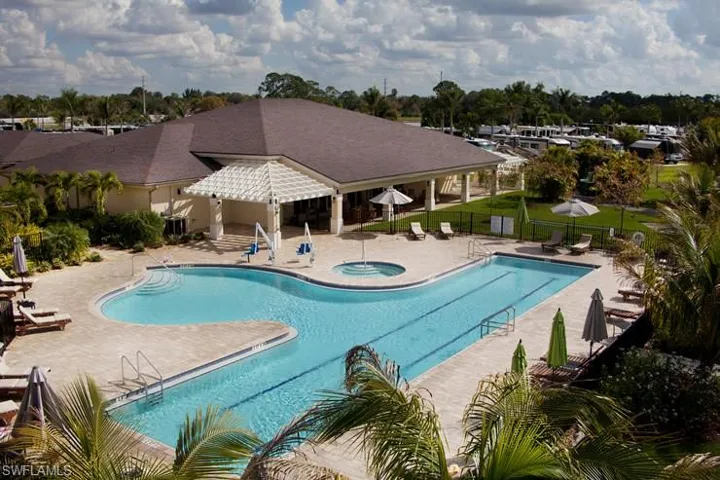 View of swimming pool with a community hot tub and a patio