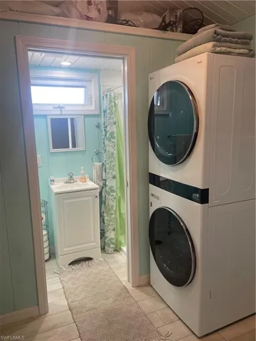 Washroom with stacked washer / dryer and sink