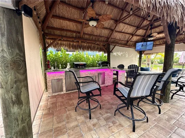 View of patio with a gazebo, ceiling fan, and exterior kitchen