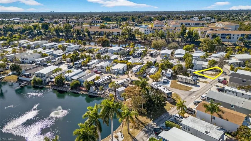 Aerial view of property's location with a large body of water and nearby suburban area