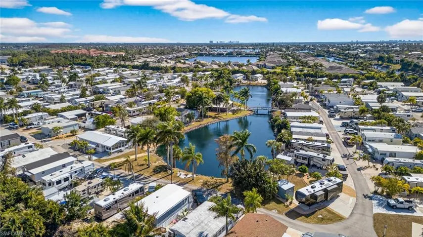 Aerial view of property and surrounding area with nearby suburban area and a nearby body of water