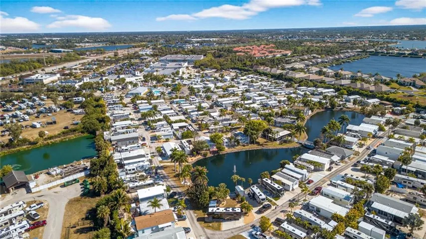 Aerial view of property and surrounding area with nearby suburban area