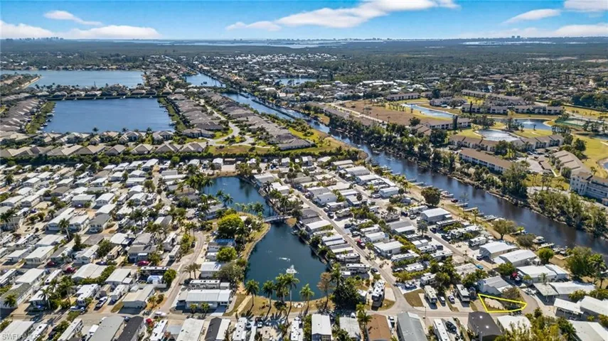 Aerial view of property's location with nearby suburban area and a nearby body of water