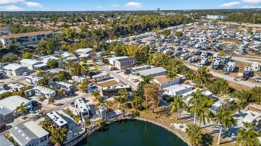 Aerial view of property and surrounding area with a large body of water and nearby suburban area