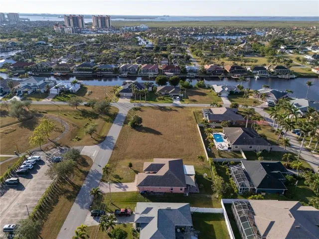 Birds eye view of property with a water view