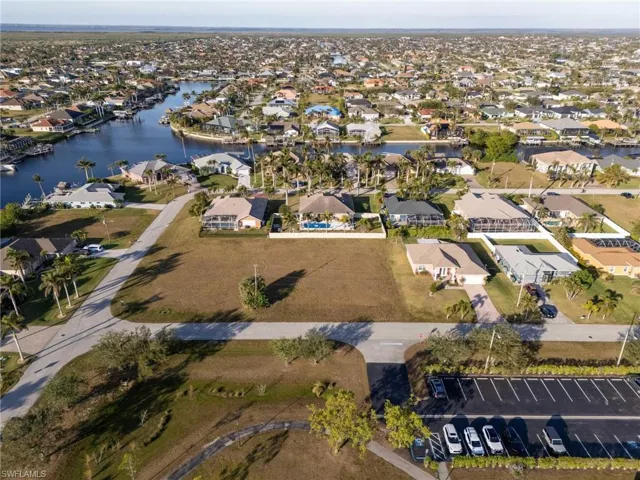 Birds eye view of property with a water view