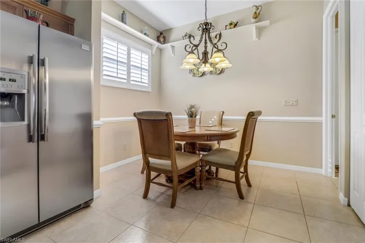 Tiled dining area featuring a chandelier