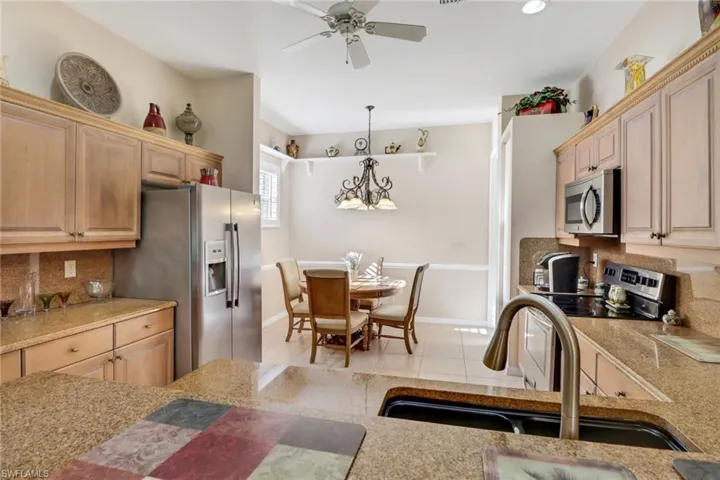 Kitchen featuring appliances with stainless steel finishes, backsplash, and light brown cabinets