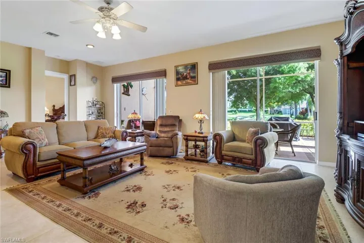 Living room featuring ceiling fan and light tile patterned floors