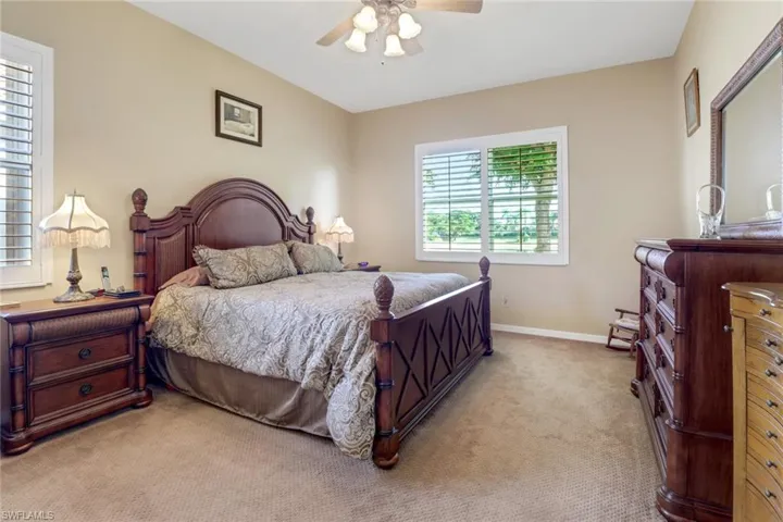 Bedroom featuring light carpet and ceiling fan