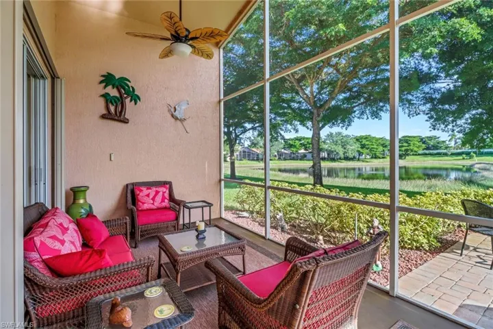 Sunroom / solarium with a water view and ceiling fan