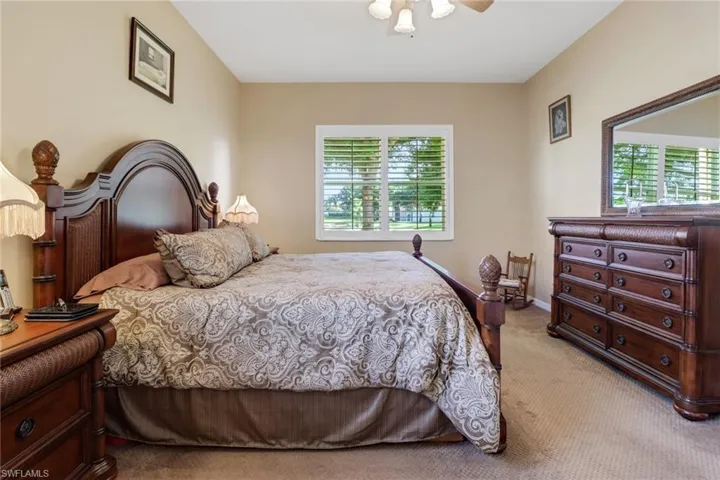 Carpeted bedroom with ceiling fan