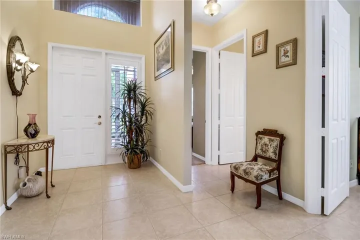 Foyer entrance featuring light tile patterned floors