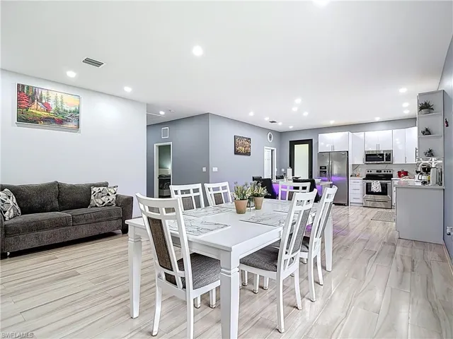 Dining area with recessed lighting and light wood-style flooring