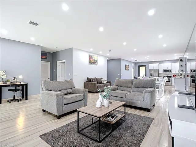 Living area featuring recessed lighting and light wood finished floors